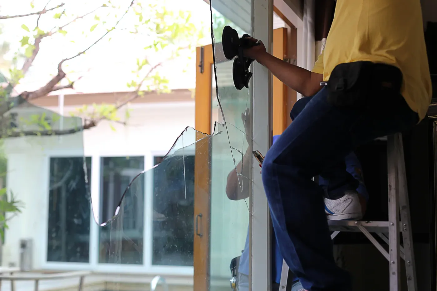 Pose à la ventouse d'un grand verre de vitrine de commerce